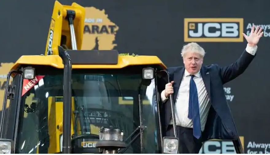 British PM poses by climbing a bulldozer