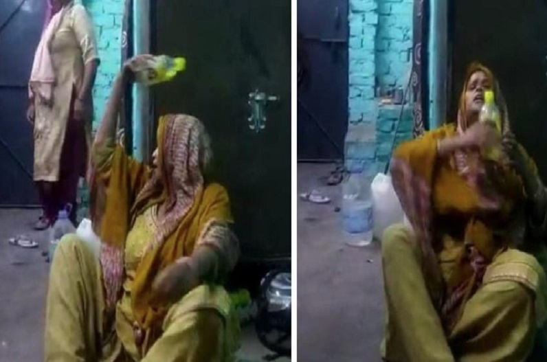 Drunk woman dancing with acid bottle on her head