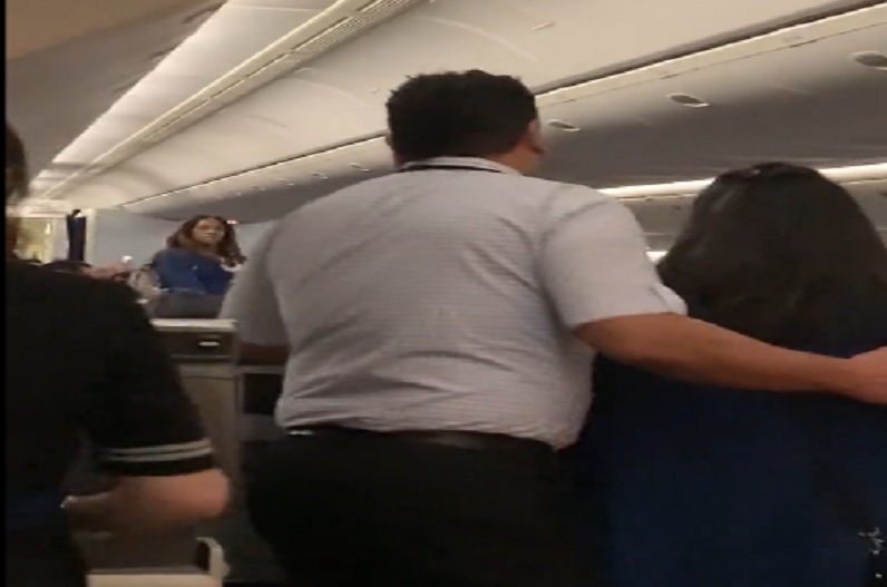 woman and air hostess on plane fight