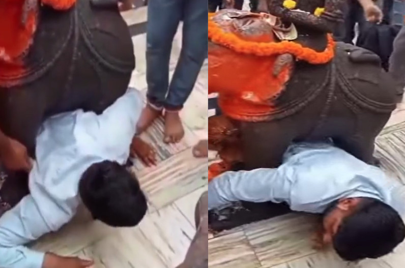 man trapped under elephant statue