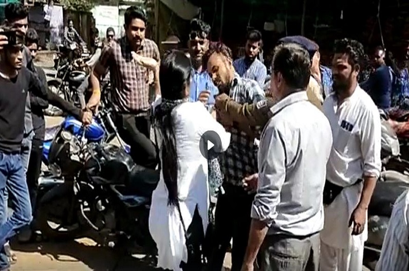 The woman slapped the young man in front of the college