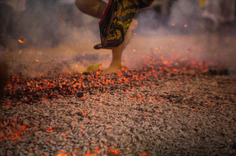 On the occasion of Holi people walk barefoot on burning coals